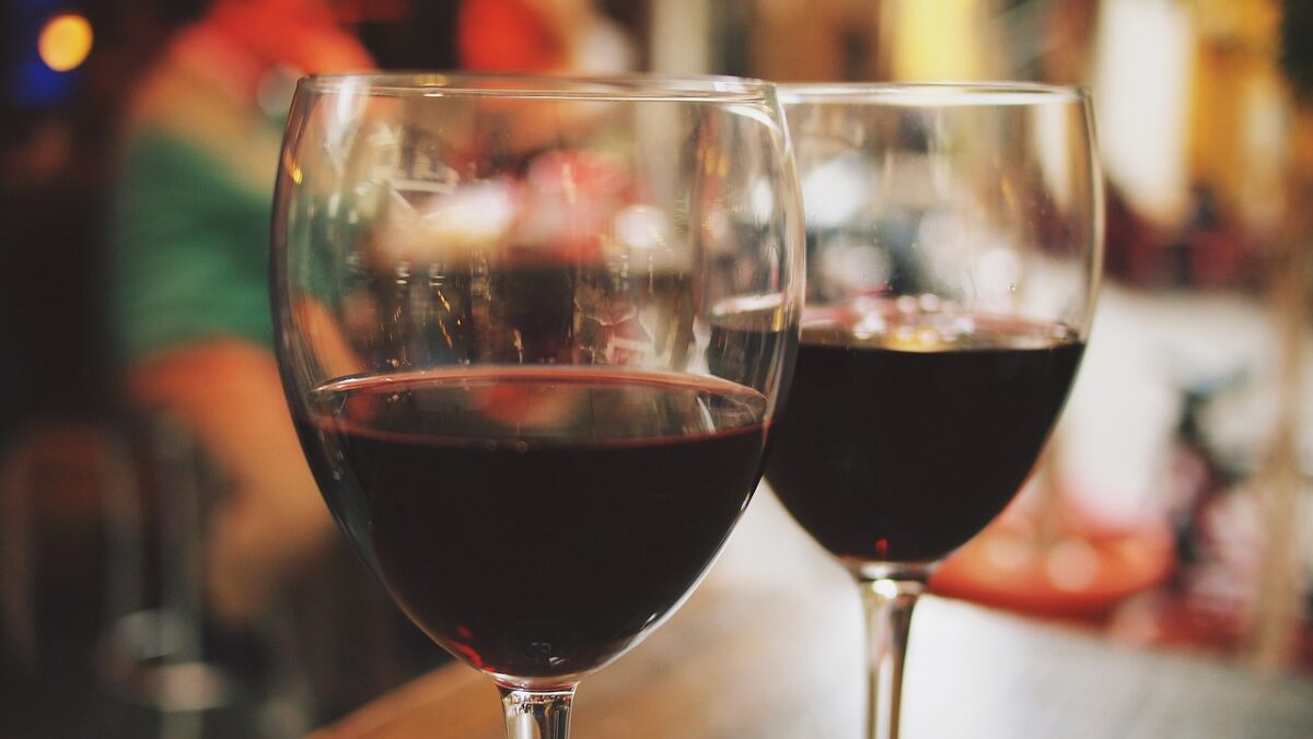 two glasses of red wine on a table