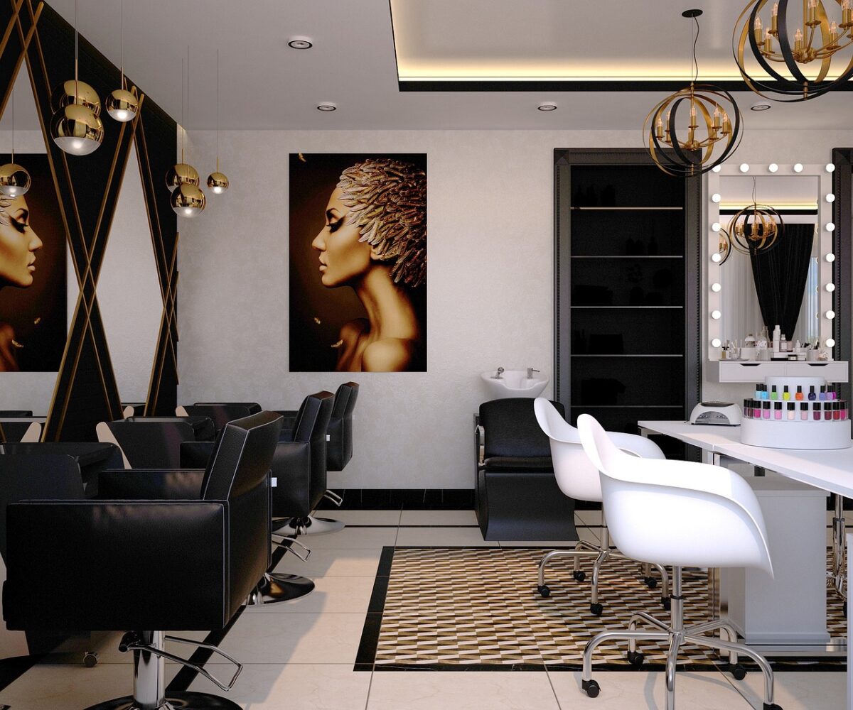 contemporary beauty salon with black leather barber chairs and white treatment chairs with art work on the walls